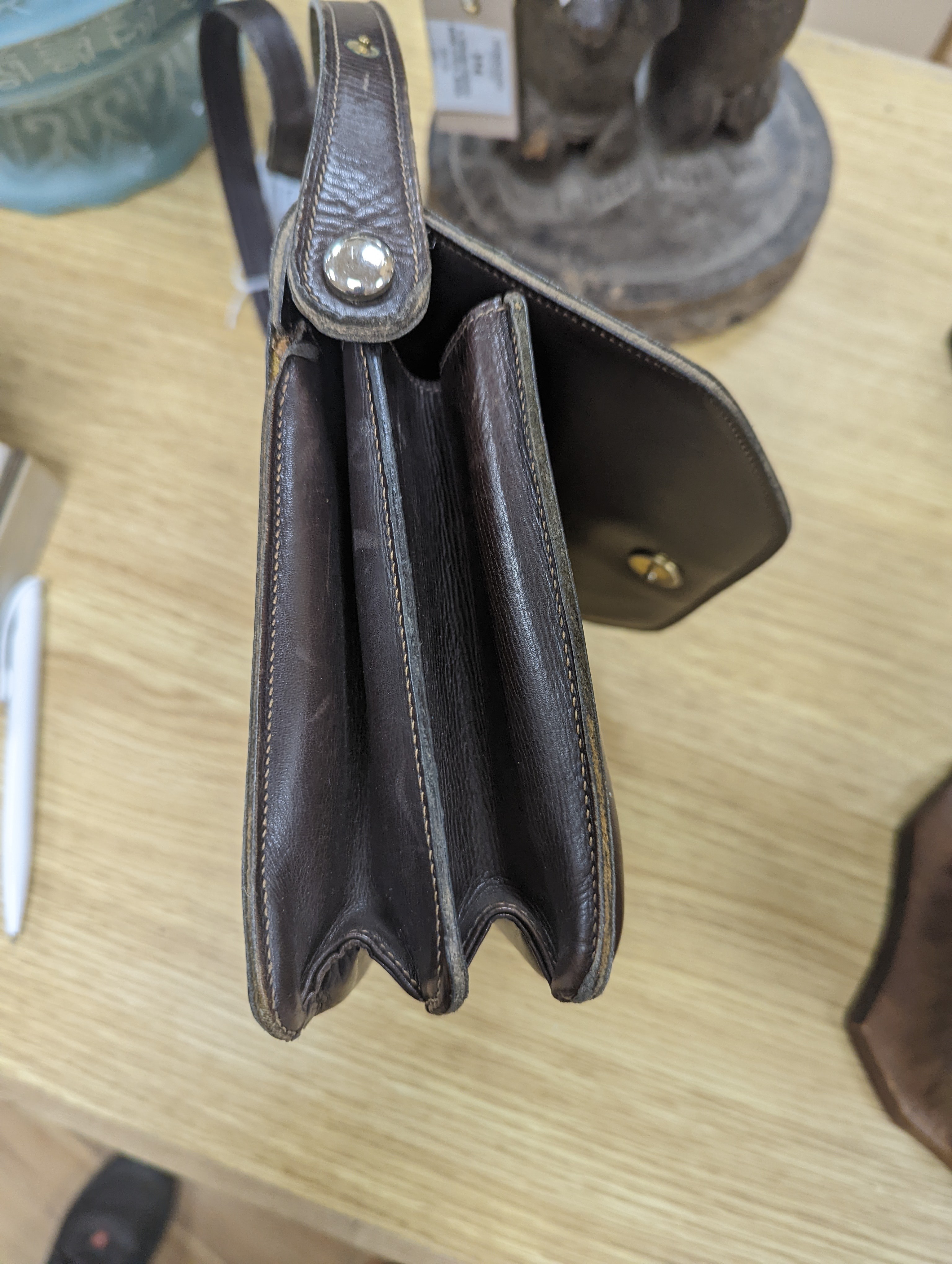A vintage brown leather handbag stamped 